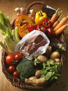 Vegetables, ham and chocolate in basket