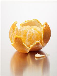Peeled mandarin orange in its skin