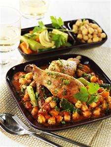Chicken legs and sausages on Mediterranean-style beans