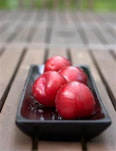 Red plums in a dish