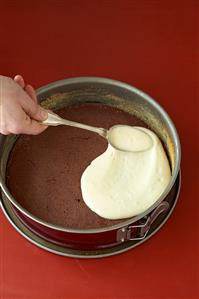Making Baumkuchen cake (spreading light mixture on chocolate layer)