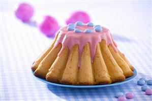 Polish Easter cake with pink icing and chocolate beans
