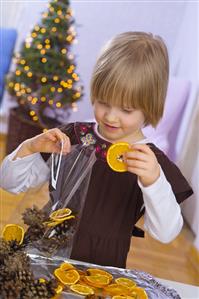 Little girl making Christmas pot-pourri