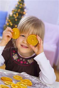 Little girl with dried orange slices