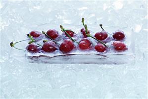 Cherries frozen in a block of ice