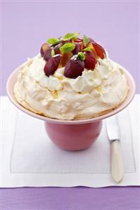 Meringue with whipped cream, plums, honey and mint