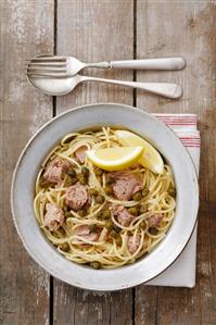 Spaghetti with tuna, capers and lemon and olive sauce