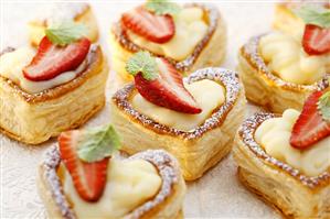 Heart-shaped vol-au-vents filled with custard & strawberries