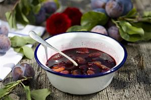 Plum compote in metal bowl