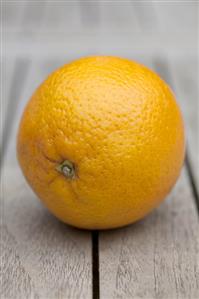 An orange on a wooden table