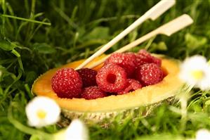 Raspberries in a melon half