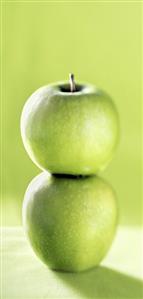 Two stacked Granny Smith apples