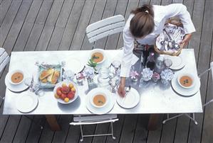 Young woman laying table