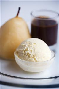 Baked pear with vanilla ice cream and chocolate sauce