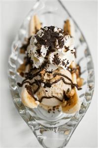 Banana split with vanilla ice cream, cream & grated chocolate