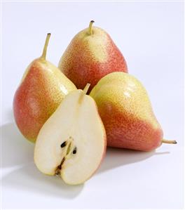 Half a pear in front of whole pears (variety: Blush)