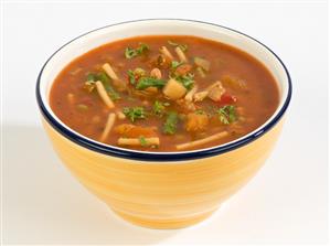 Minestrone in yellow soup bowl