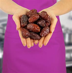 Hands holding dried dates