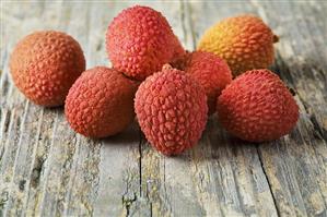 Lychees on wooden background