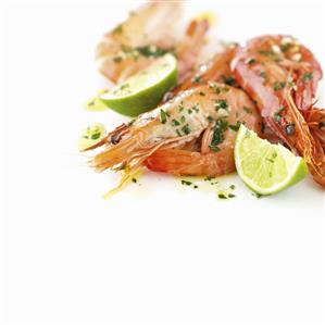 Prawns with lime wedges and herbs