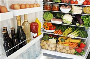 Various foods in an open refrigerator