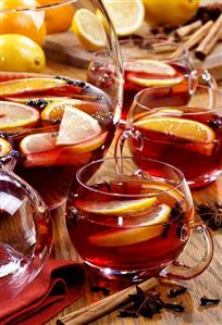 Mulled wine in punch bowl and glass cups