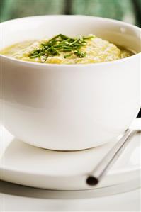 Pea soup with chives in a bowl