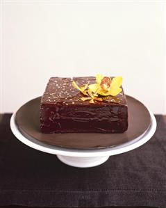 A square chocolate cake with gold