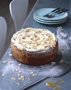 Apricot almond cake with yoghurt cream on cake rack