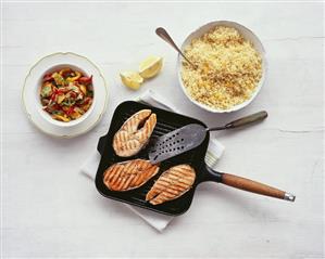 Salmon in grill pan with peppers and lemon couscous