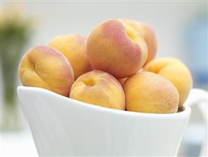 Apricots in white porcelain bowl