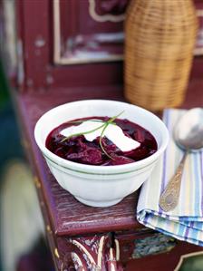 A bowl of borscht with sour cream