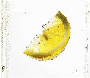 Lemon wedge in mineral water