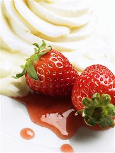 Two strawberries with whipped cream