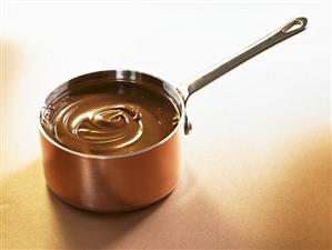 Melted chocolate in a copper pan