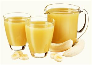 Banana juice in jug and two glasses and fresh banana