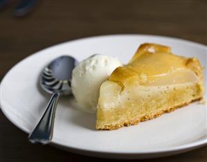 A piece of apple tart with vanilla ice cream