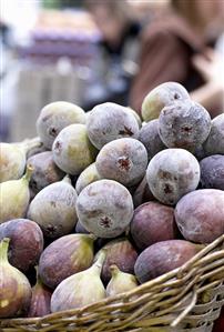 A basket of ripe figs on a market stall