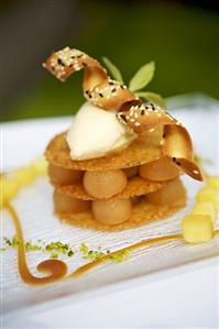 Poached apple with vanilla ice cream and wafers