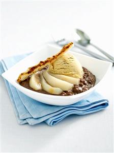 Nut ice cream with pears in chocolate sauce