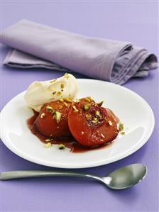 Poached peach with cream and pistachios