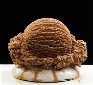 Single scoop of chocolate ice cream on a dish