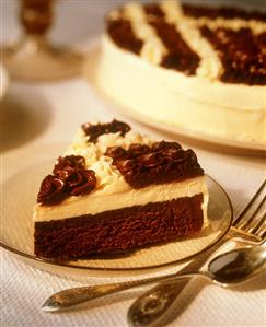 A Slice of a Chocolate Torte with Vanilla and Chocolate Frosting