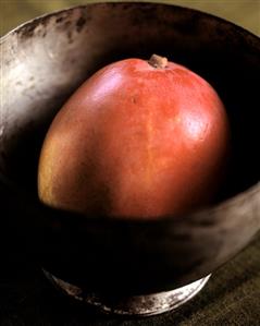 Whole Mango in a Metal Bowl