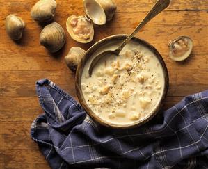 Clam Chowder in a Wooden Bowl with a Wooden Spoon; Fresh Clam