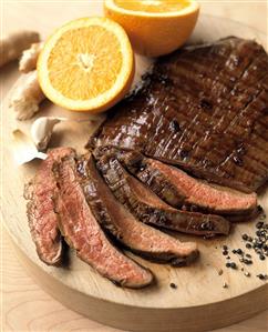 Sliced Flank Steak on a Wooden Board