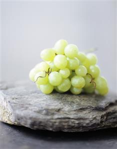 A Bunch of Green Grapes on Stone