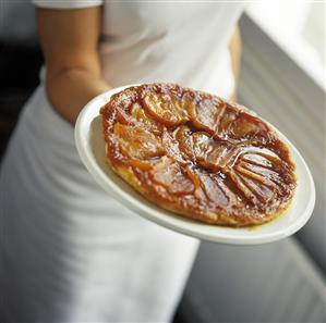 A Woman Holding a Tarte Tatin