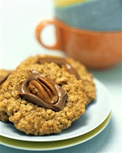 An Oatmeal Cookie Topped with Chocolate and a Walnut