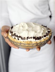 Hands Holding a Banana Cream Pie